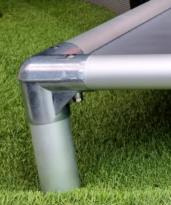 Close-up of a chromed zinc-alloy corner joining two anodised aluminium rails and a leg on a Cofa Bed.